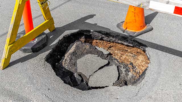 sinkhole-deep-pothole-in-a-road