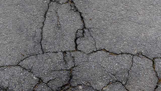 cracked asphalt needing maintenance