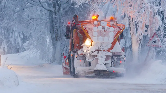 snow plow truck driving in the snow