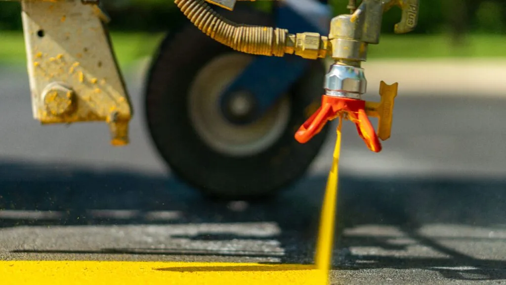 close up of parking lot striping machine