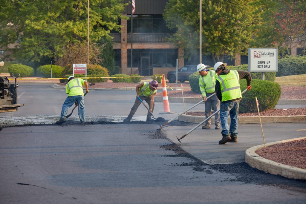 plm paving employees working in a credit union parking lot