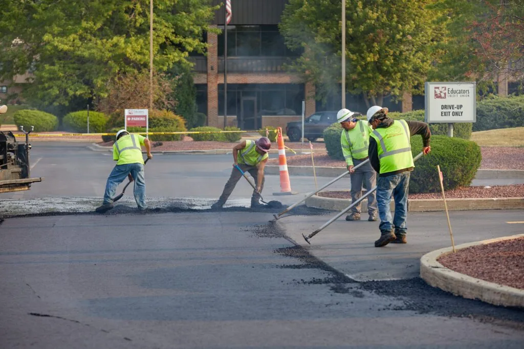 plm paving employees working in a credit union parking lot