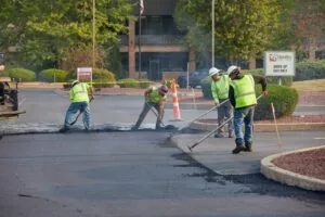plm paving employees working in a credit union parking lot