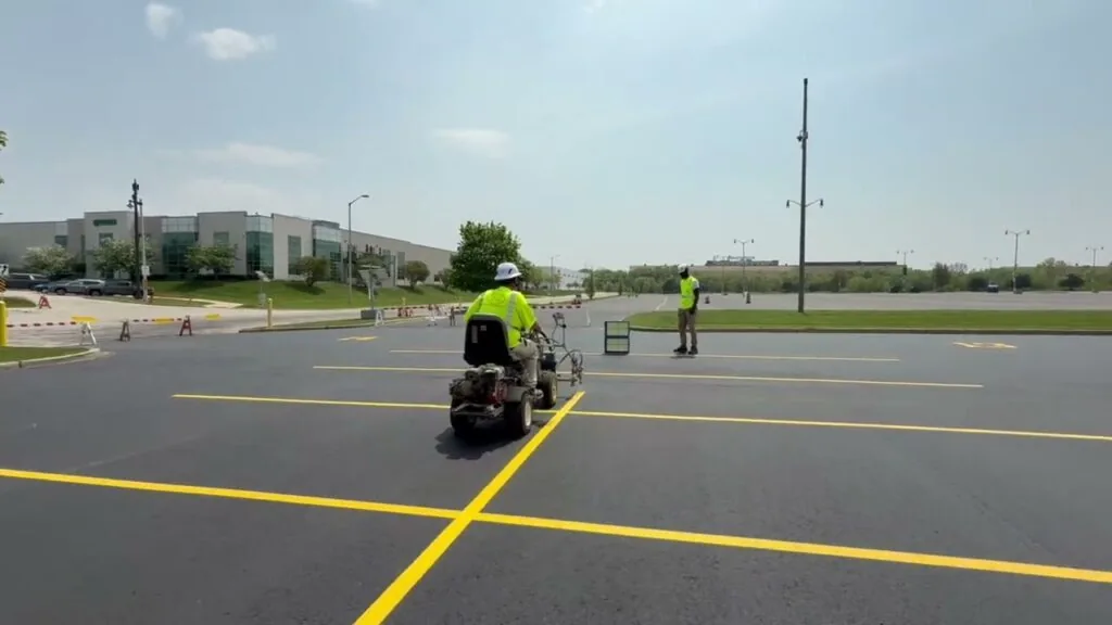 Man using equipment to do parking lot paving in Milwaukee