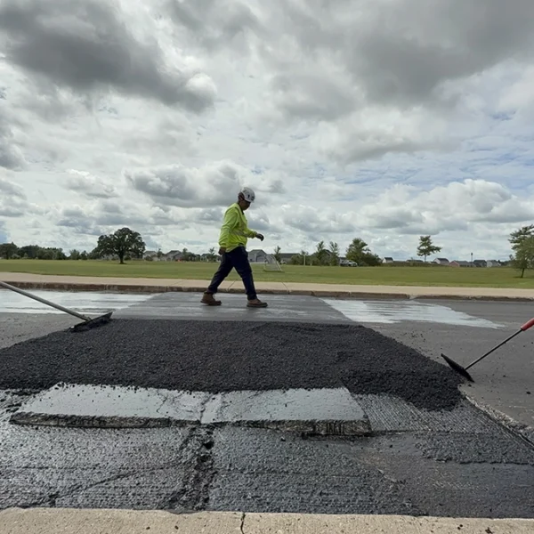 Raking and walking on fresh pave