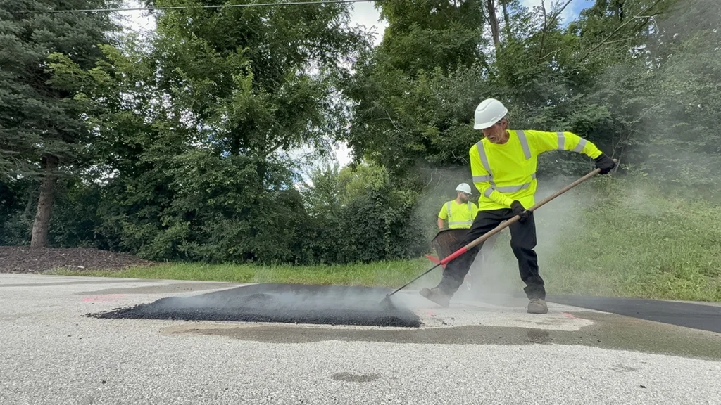 Raking hot pavement