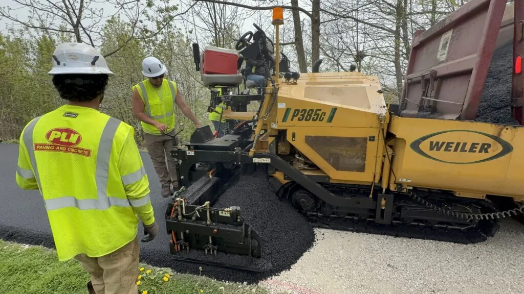 PLM employees laying down fresh asphalt at Juneau Park.