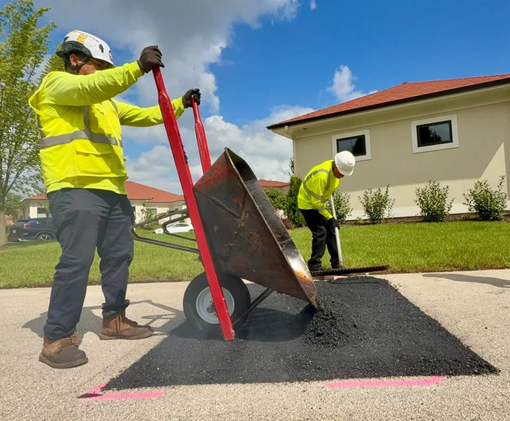 PLM Paving crew performing asphalt repair service.