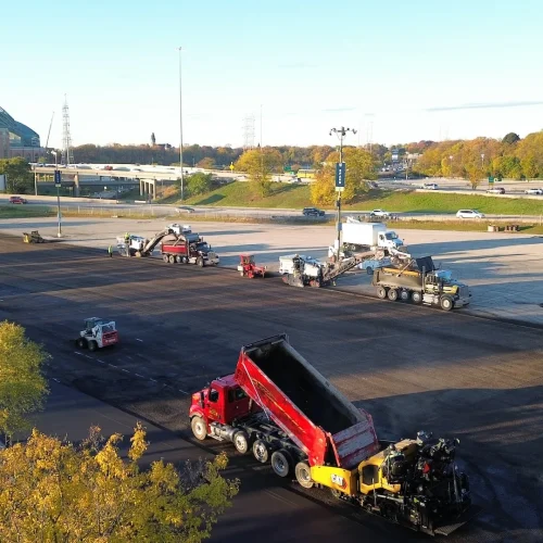 Aerial shot of two mills and paver running at the same time at American Family Field parking lot.