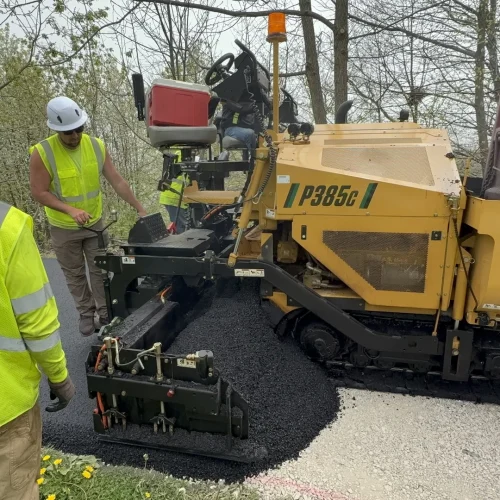 PLM employees laying down fresh asphalt at Juneau Park.