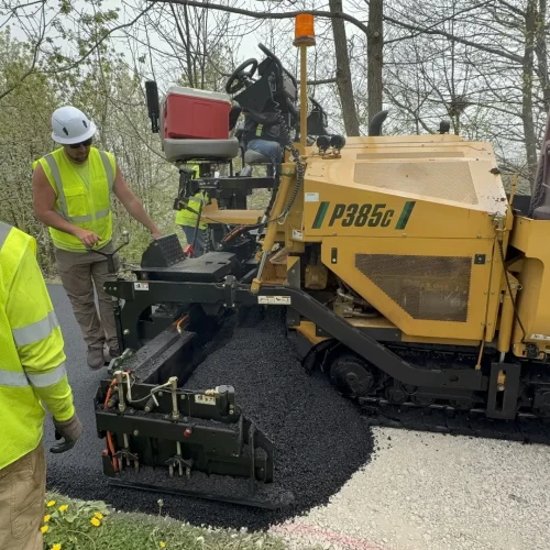 PLM employees laying down fresh asphalt at Juneau Park.