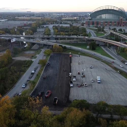 Aerial shot of milling and paving simultaneously happening at American Family Field parking lot.