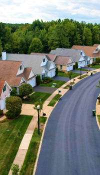 Property-Management.png row of suburban house with a road that is curving to the right