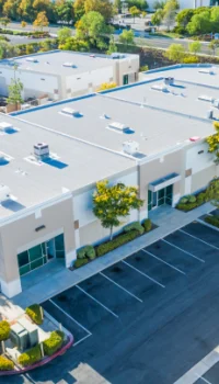 aerial view of a commercial building and parking lot