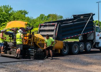 plm paving employees working on the side of the road