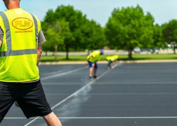 plm paving employees painting parking lot lines